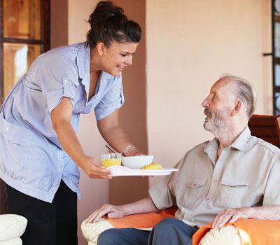 Care home nurse helping old man - Care Sourcer launches free health and wellbeing support