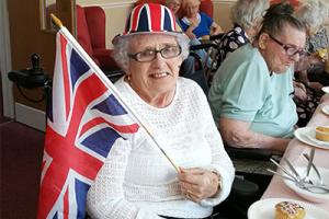 elderly woman attending indoor street party