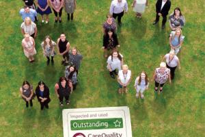 Home Instead Senior Care staff celebrating receiving their 50th “outstanding” CQC rating
