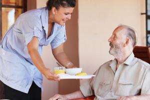 Care home nurse helping old man - Care Sourcer launches free health and wellbeing support 