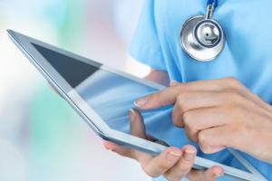 Nurse using care home technology after CQC State of Care report