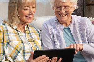 Two people watching a TV advert on a tablet
