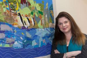 Care home artist Sarah with her paintings 